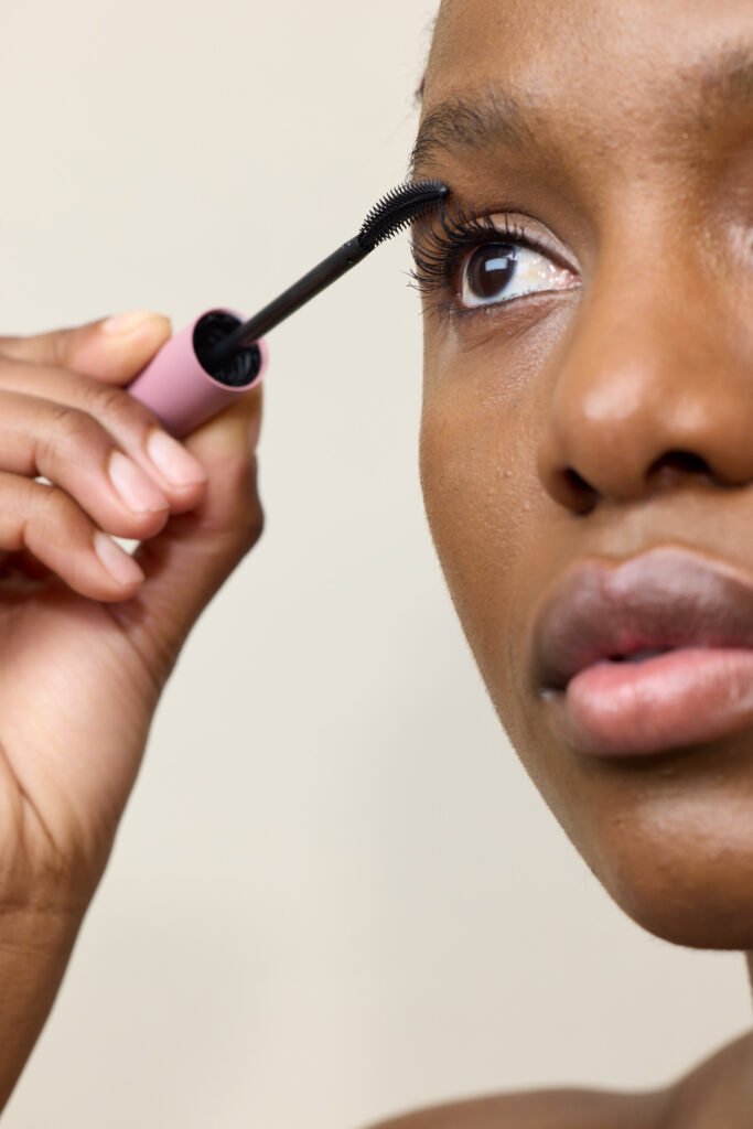 Close up of woman applying dark mascara